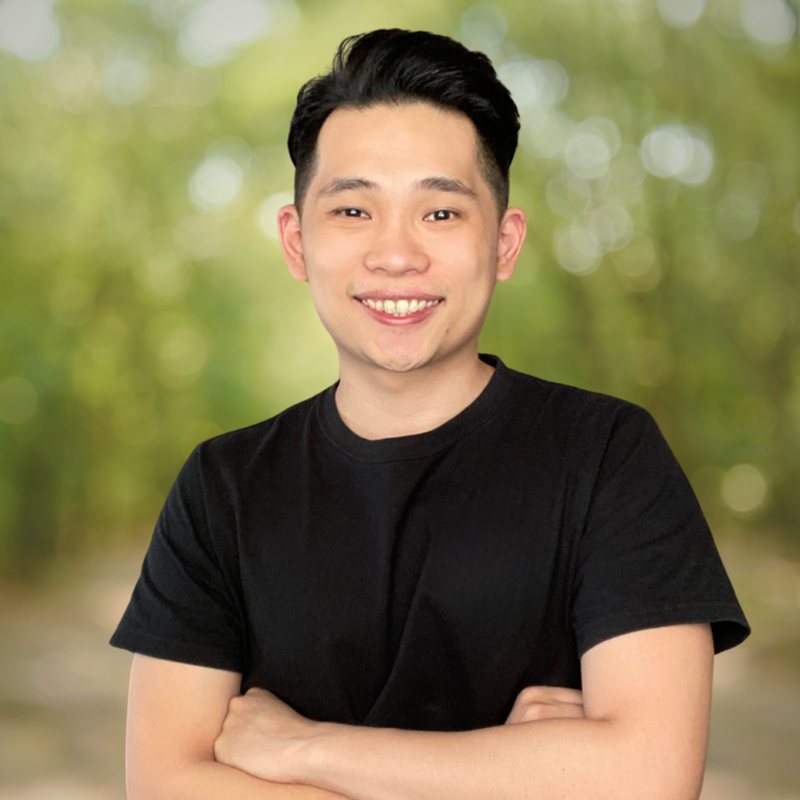 Chenming Yong, arms crossed, smiling outdoors